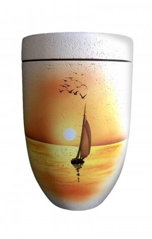 Biodegradable Urn out of shell limestone with sailing boat in sunset
